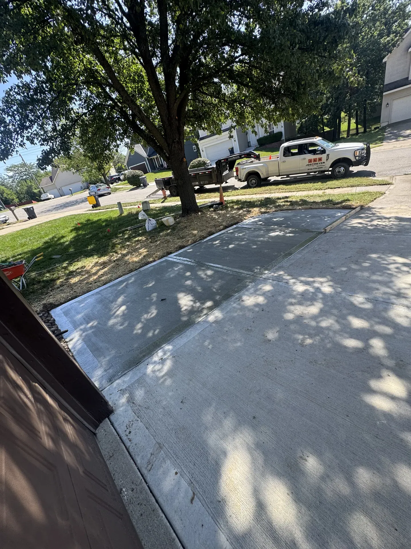 Fresh concrete driveway pour with Jostmeyer truck in background