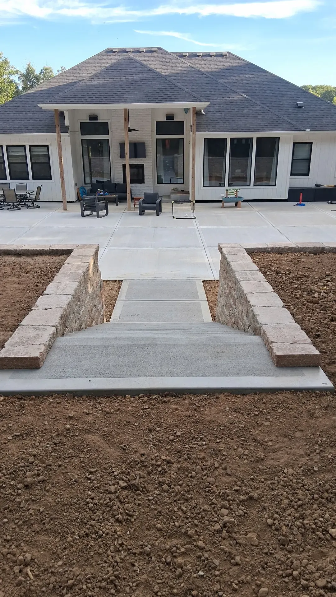 Concrete staircase alongside stone retaining wall