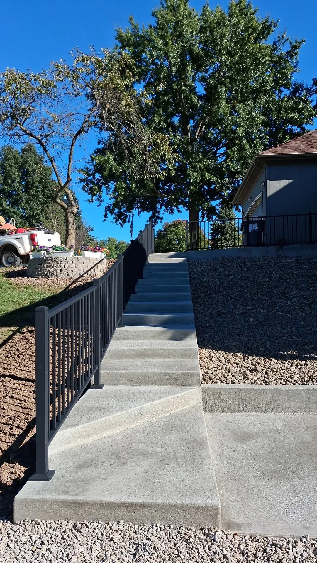 Concrete steps with black aluminum railing