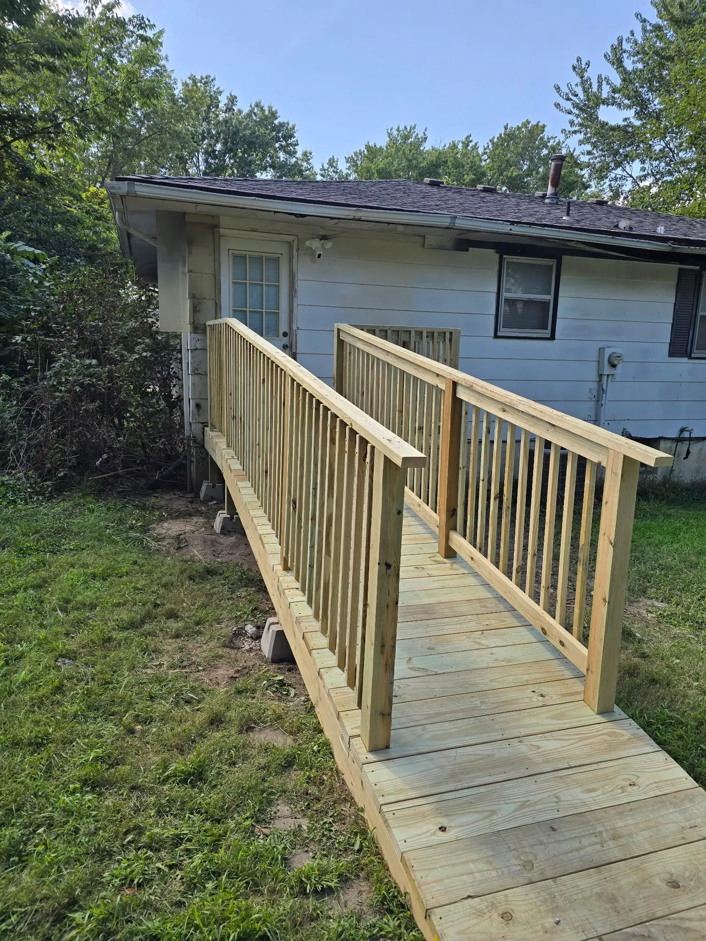 Deck accessibility ramp with railing — ADA-compatible construction