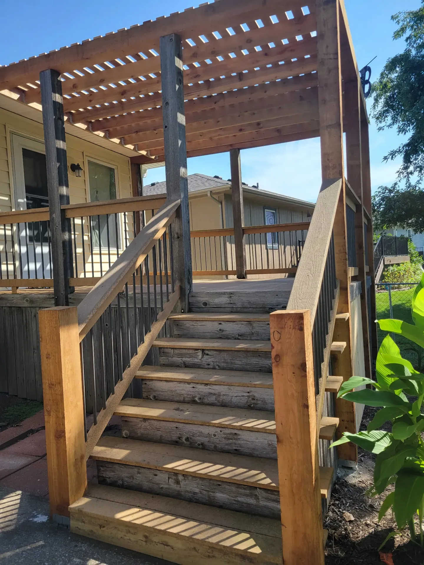 Wood deck with pergola and exterior staircase