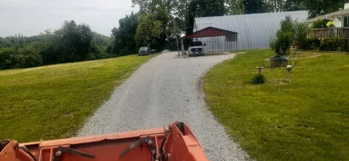 Rural gravel driveway viewed from tractor perspective