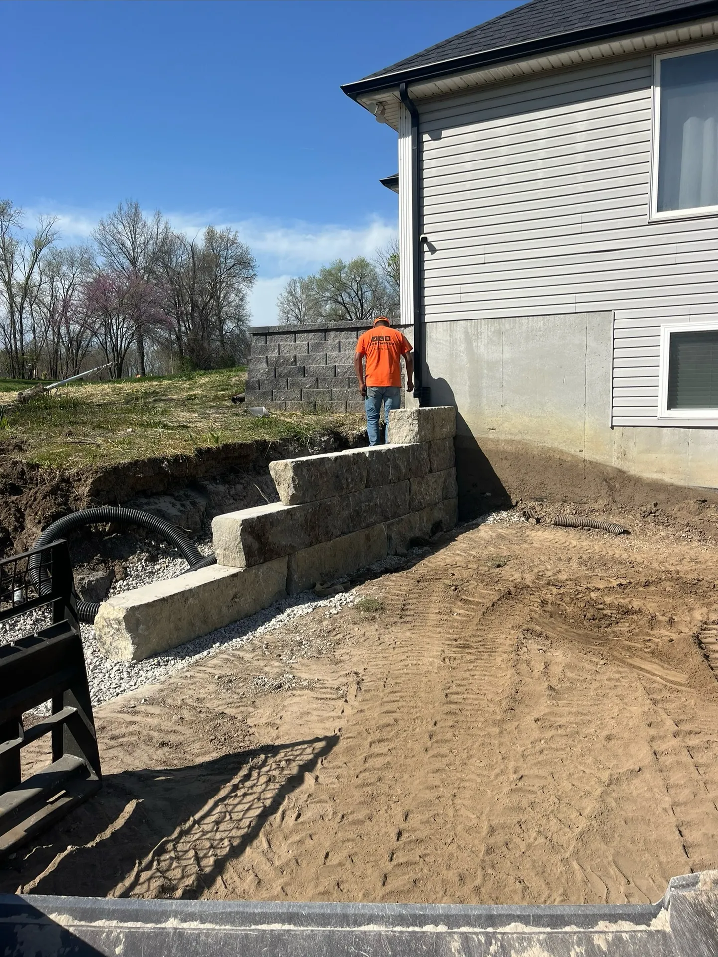 Retaining wall construction at house corner