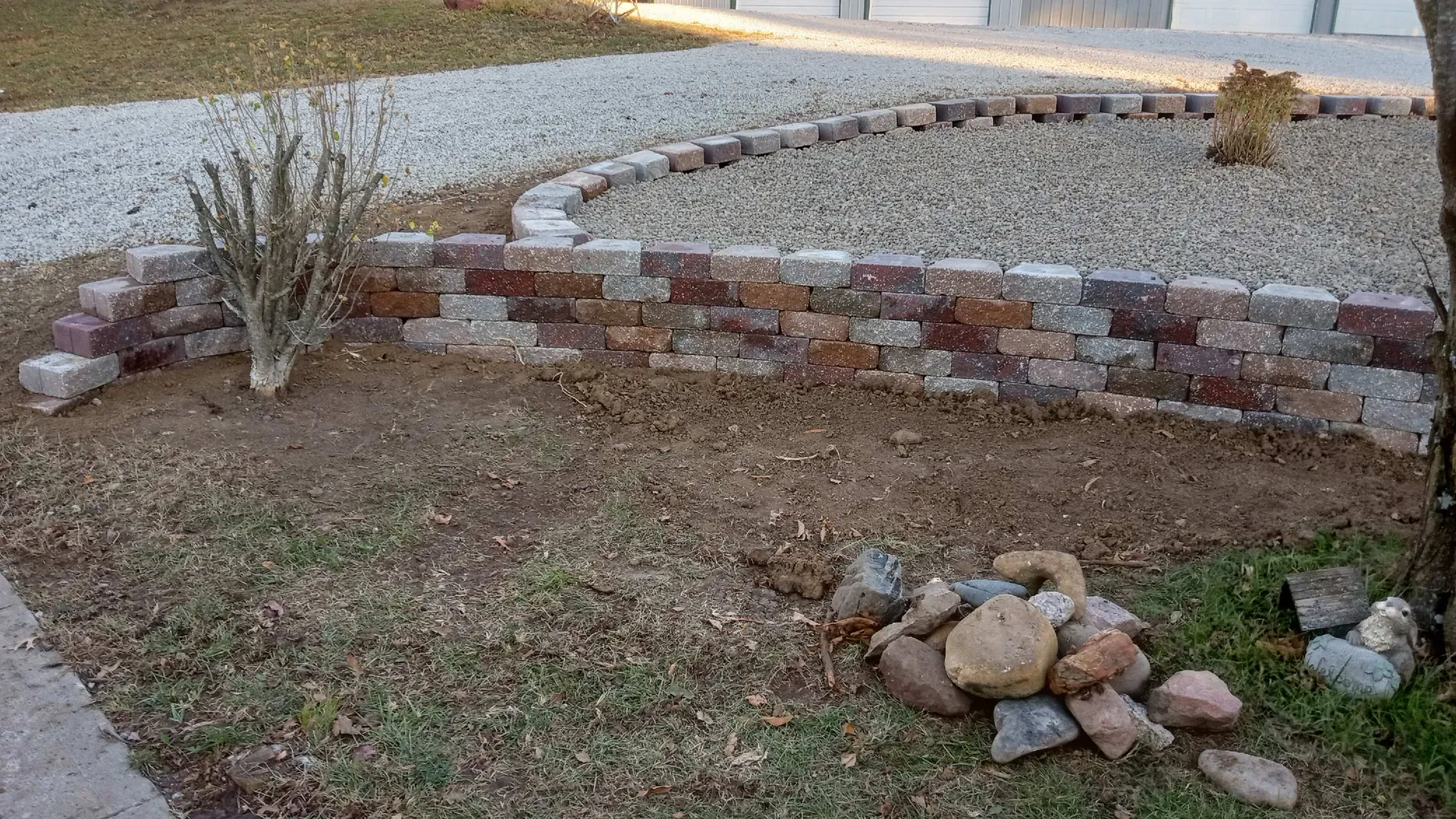 Curved retaining wall with decorative rock finish
