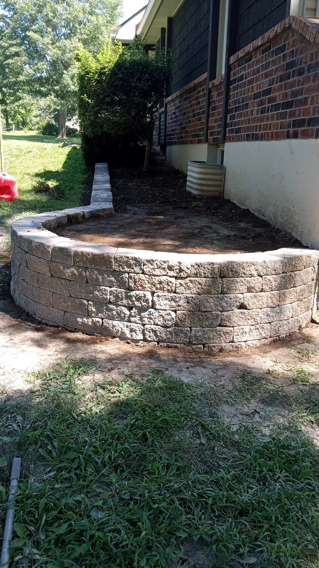Stone retaining wall at foundation