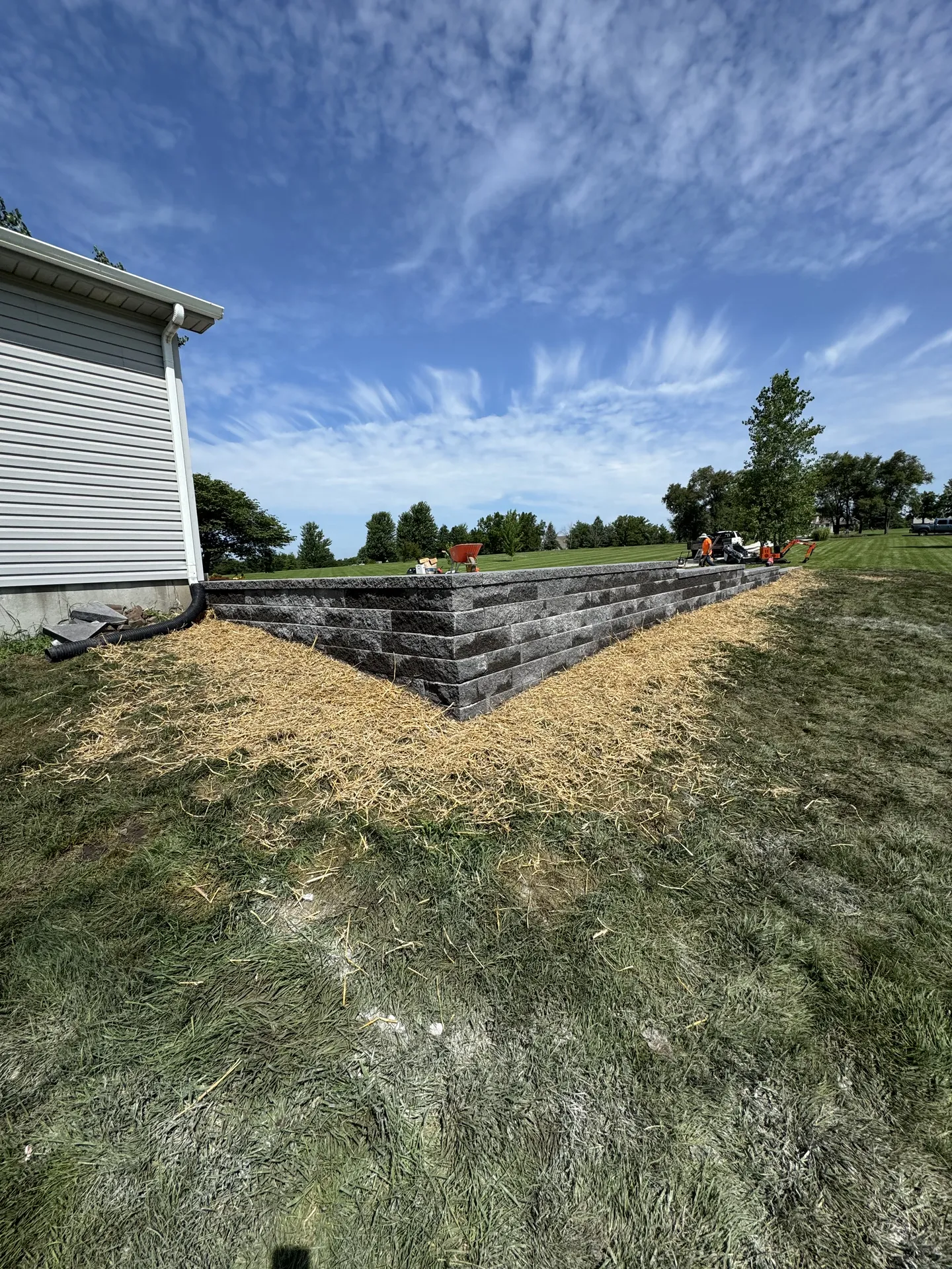 Tiered retaining wall with finished backyard landscaping