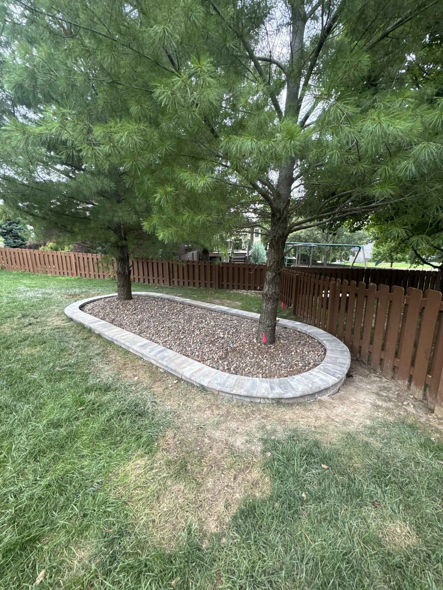 Stone tree ring retaining wall wide view