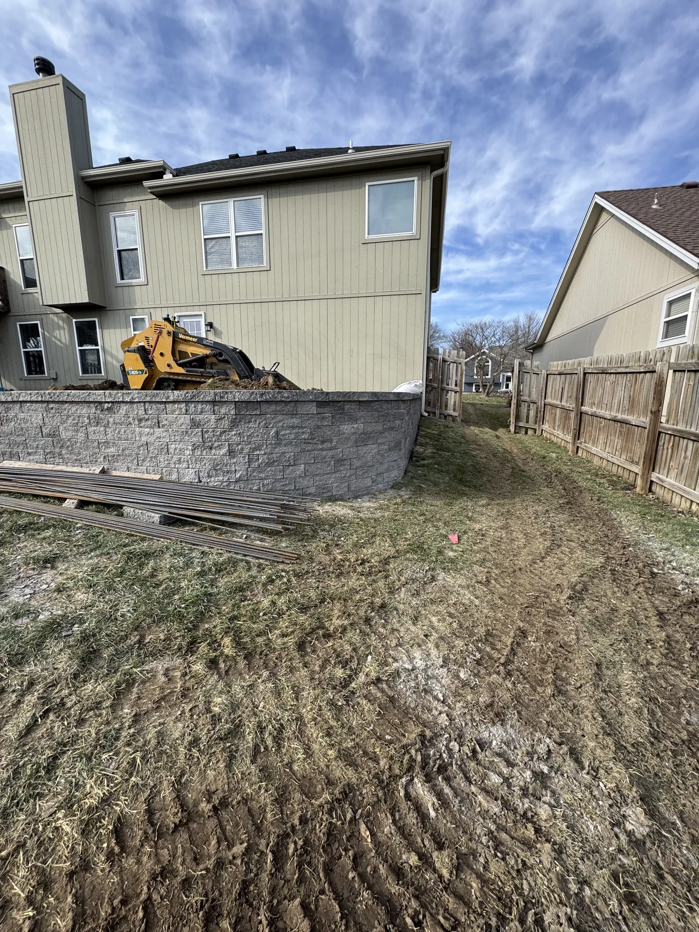 Retaining wall under construction with excavator